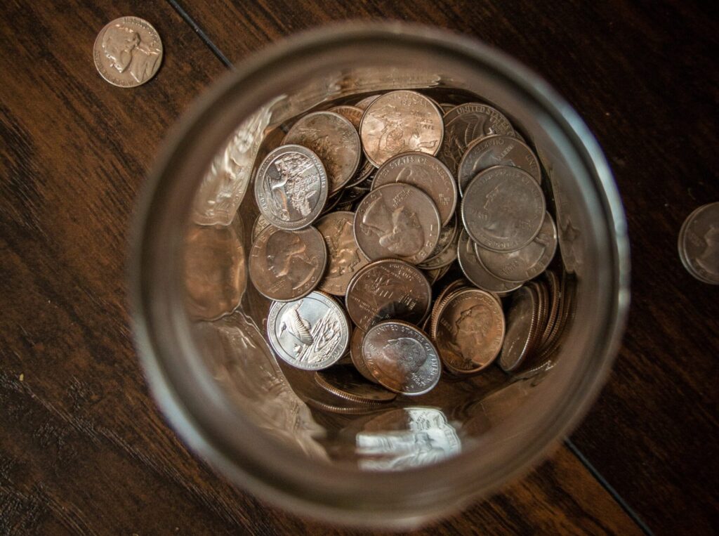 jar of change on wooden table